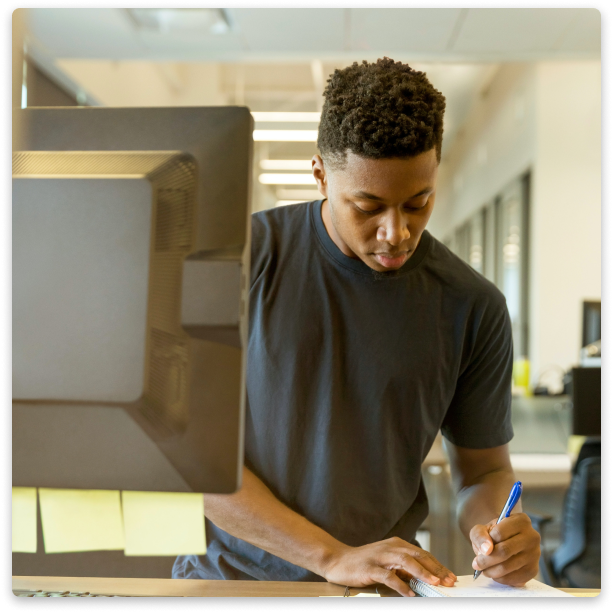 A man writing on a piece of paper