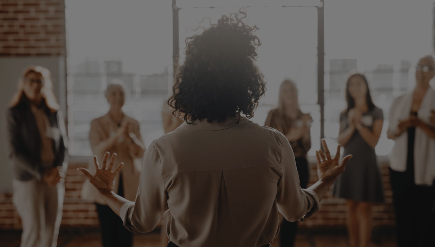 A person facing a group of people